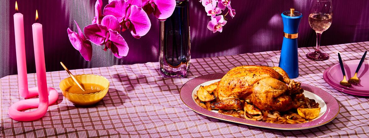 Roasted chicken on fuchsia colored table setting
