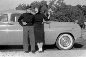 Old photo of couple leaning on car