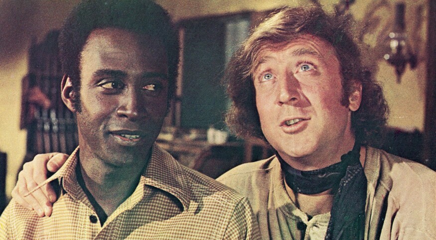 Actor Gene Wilder (right) puts his arm around the shoulder of Cleavon Little in a still from the film, 'Blazing Saddles,' directed by Mel Brooks, 1974.