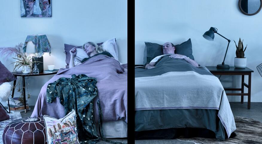 Couple sleeping side by side in separate beds.