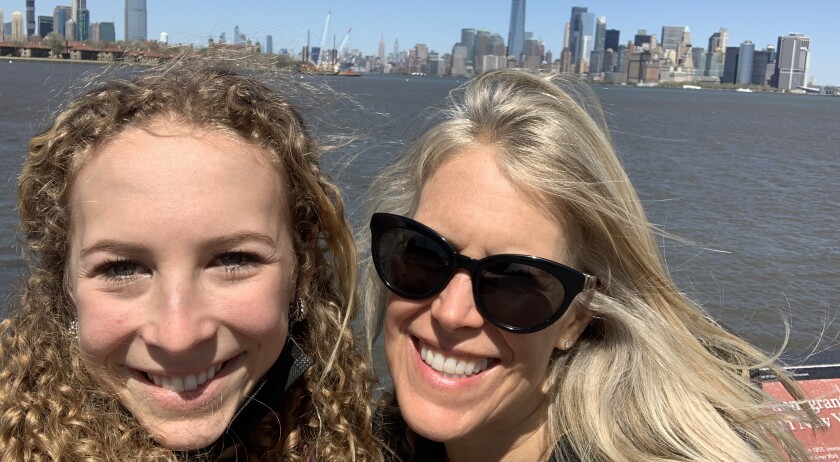 mom and daughter with skyline behind them