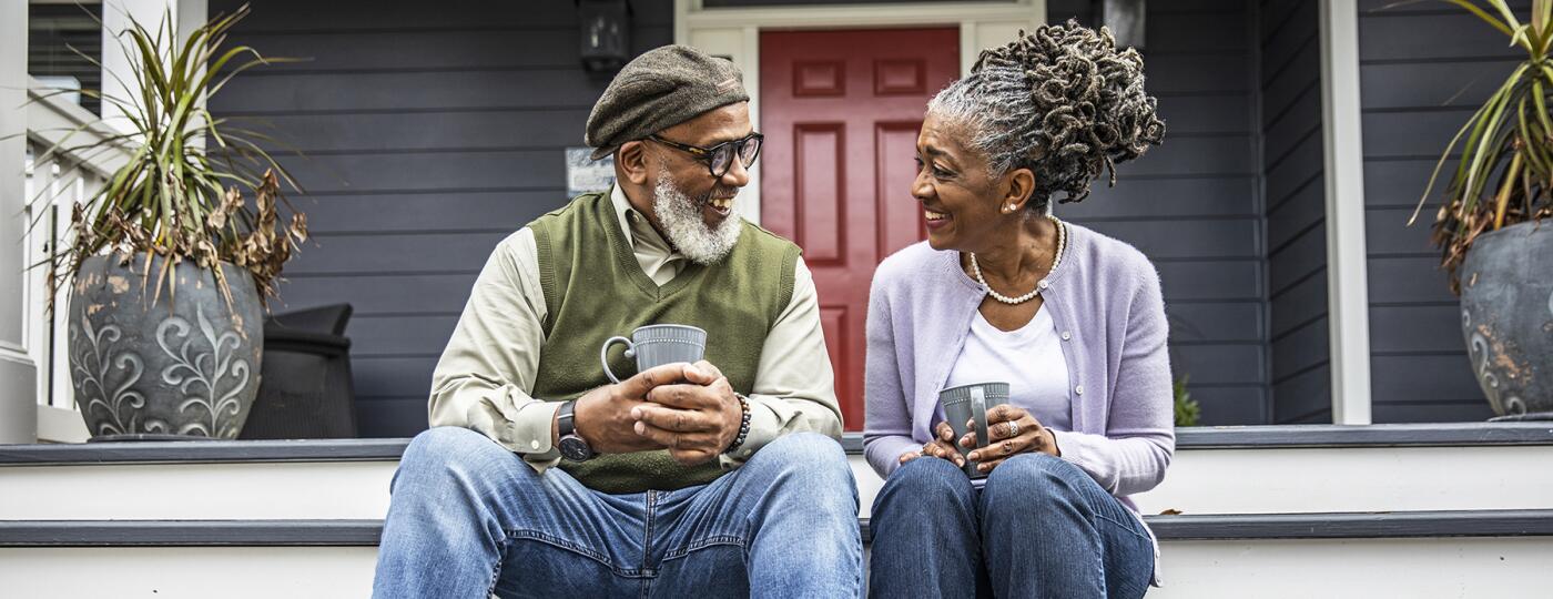 image_of_couple_sitting_on_front_porch_GettyImages-1355067016_1800