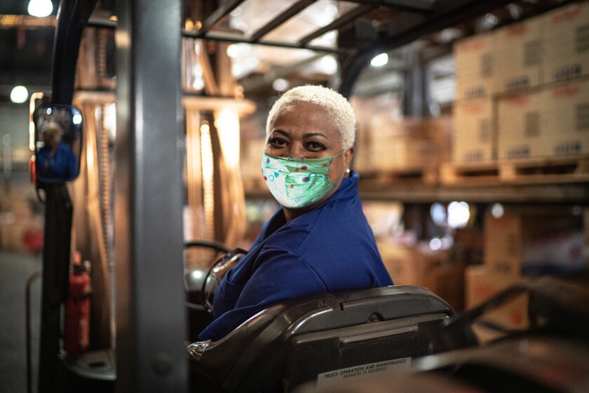 woman_wearing_mask_working_in_warehouse_GettyImages-1264076516