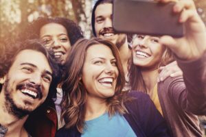 Millennials taking group selfie