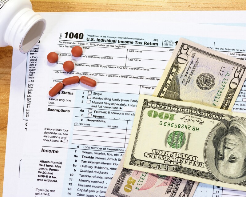 aspirins make a sad face on a tax form