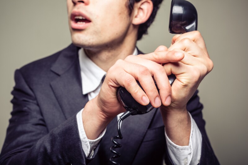 Businessman covering the phone