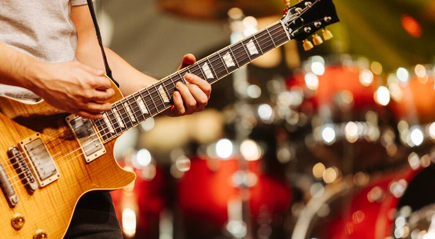Musician playing guitar in live concert