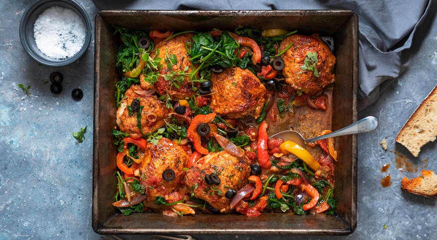 Chicken thighs in pepper and tomato sauce= with spinach and black olives