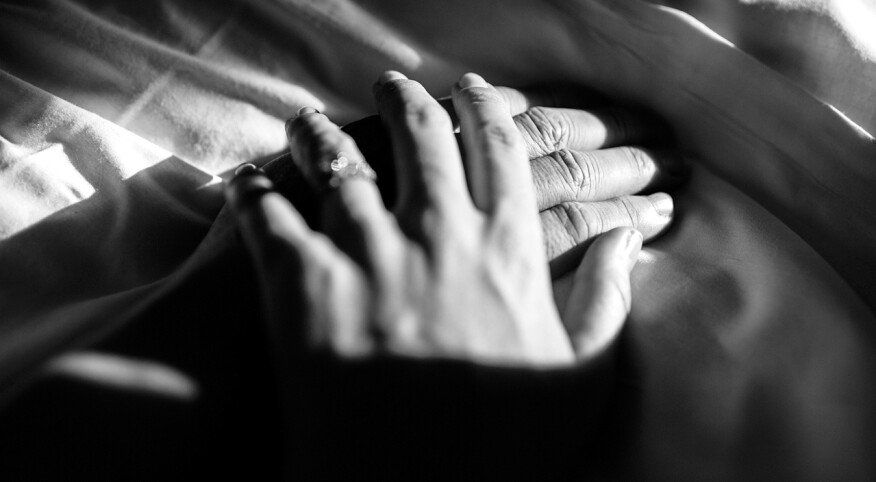 black and white image of father and daughter holding hands