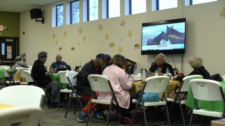 seniors sitting at table in senior home