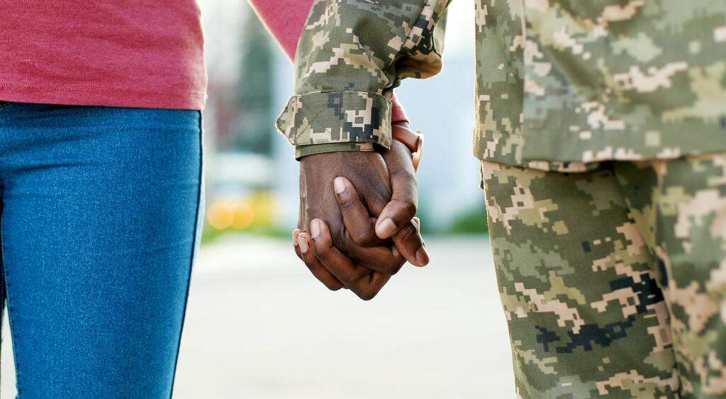 image_of_woman_holding_hands_with_military_man_shutterstock_1788953663_1800