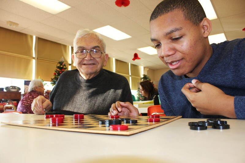 Sage Ted and Seeker Kyree play each other in a game of checkers during the Sages & Seekers program in Spring Grove, PA.