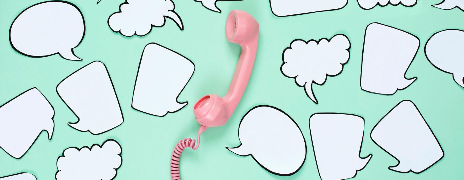 Pink phone used to stay in touch with friends surrounded by speech bubbles.