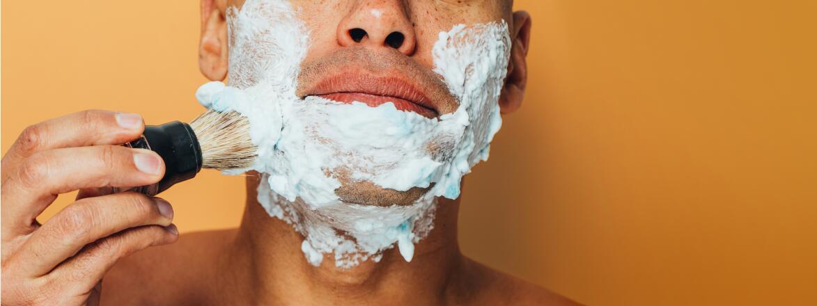 man applying shaving cream to his face