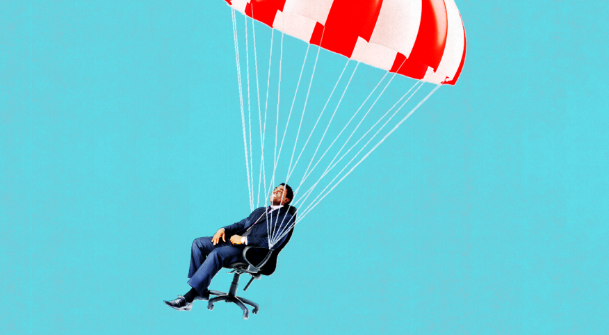 Man in work chair attached to parachute