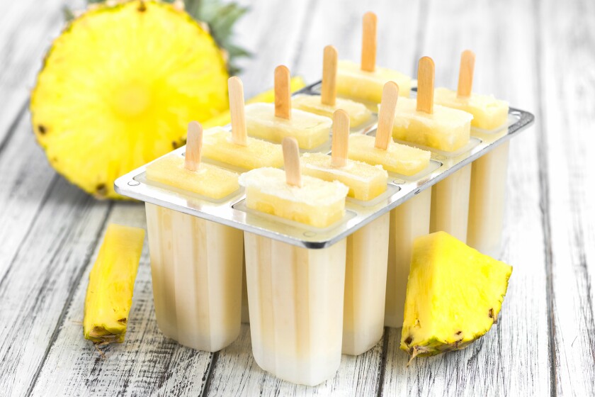 Wooden table with Pineapple Pipsicles (selective focus)