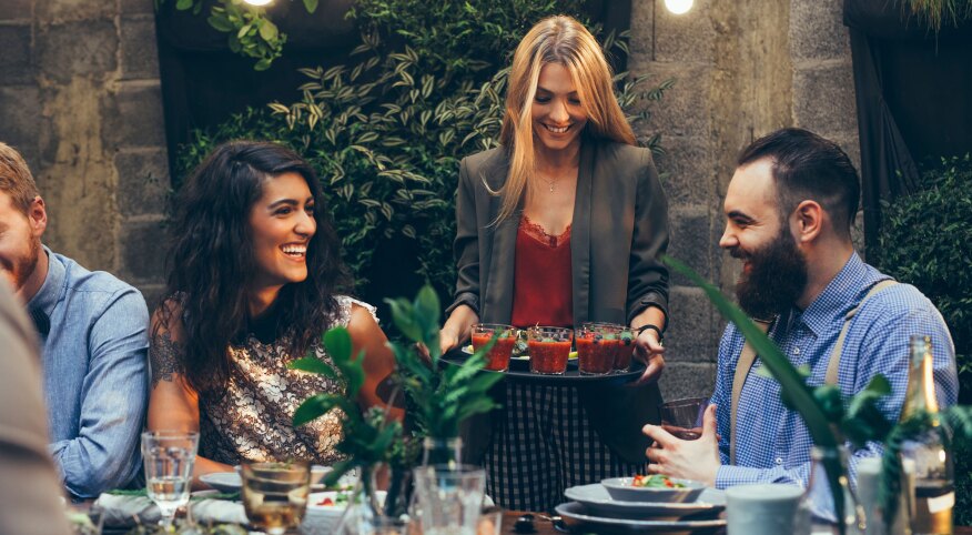 Woman serving a tray of food at party