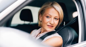 A Happy Beautiful Blonde Businesswoman Enjoying Driving Her Car