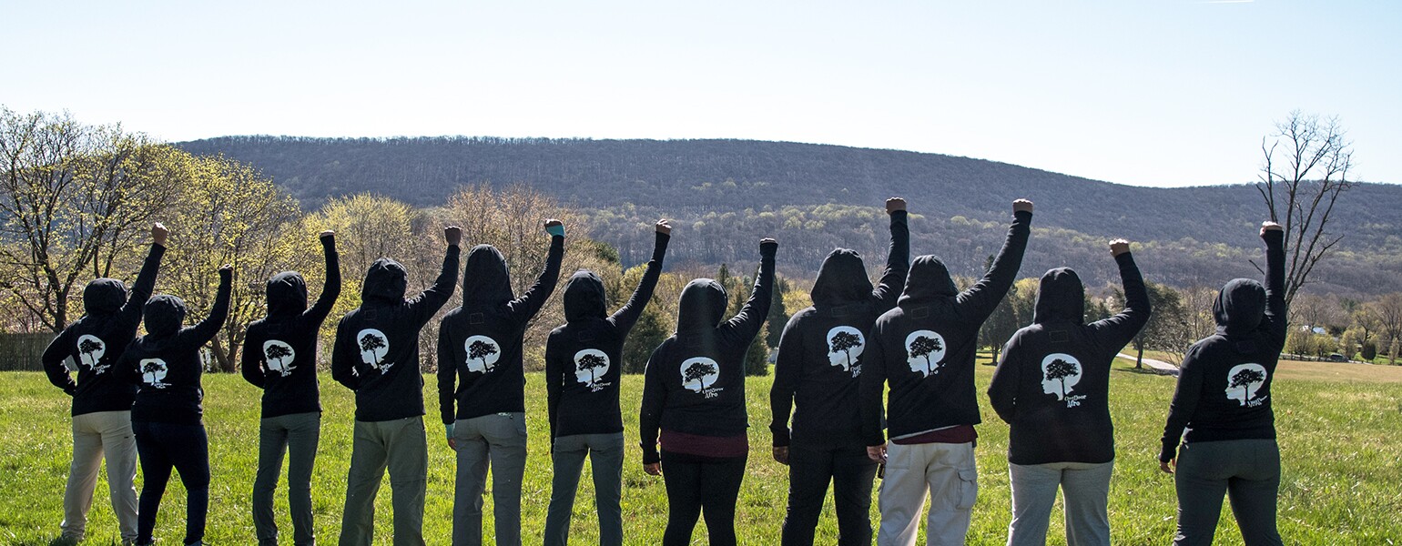 image_of_group_of_hikers_with_fists_in_air_Outdoor Afro_FistsUp_1540.jpg