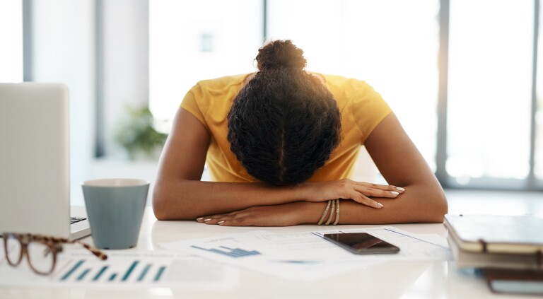 image_of_woman_with_head_down_on_desk_GettyImages-1064567962_1800