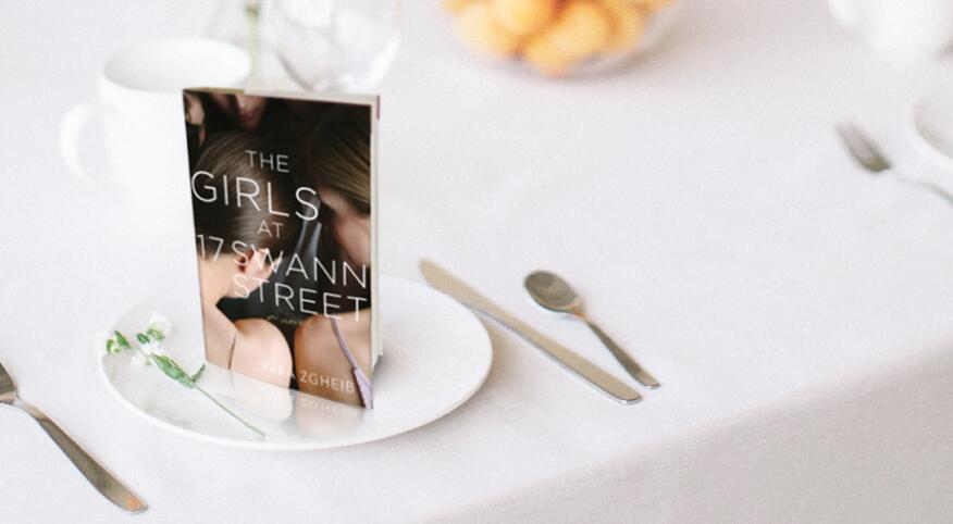 An image of Yara Zgheib's new novel, The Girls at 17 Swann Street, staged on a dining table.