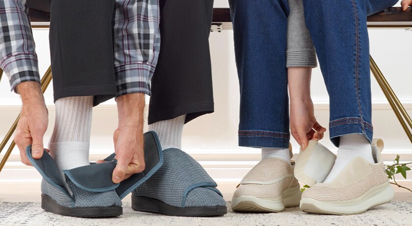 Two pairs of feet putting on Silverts