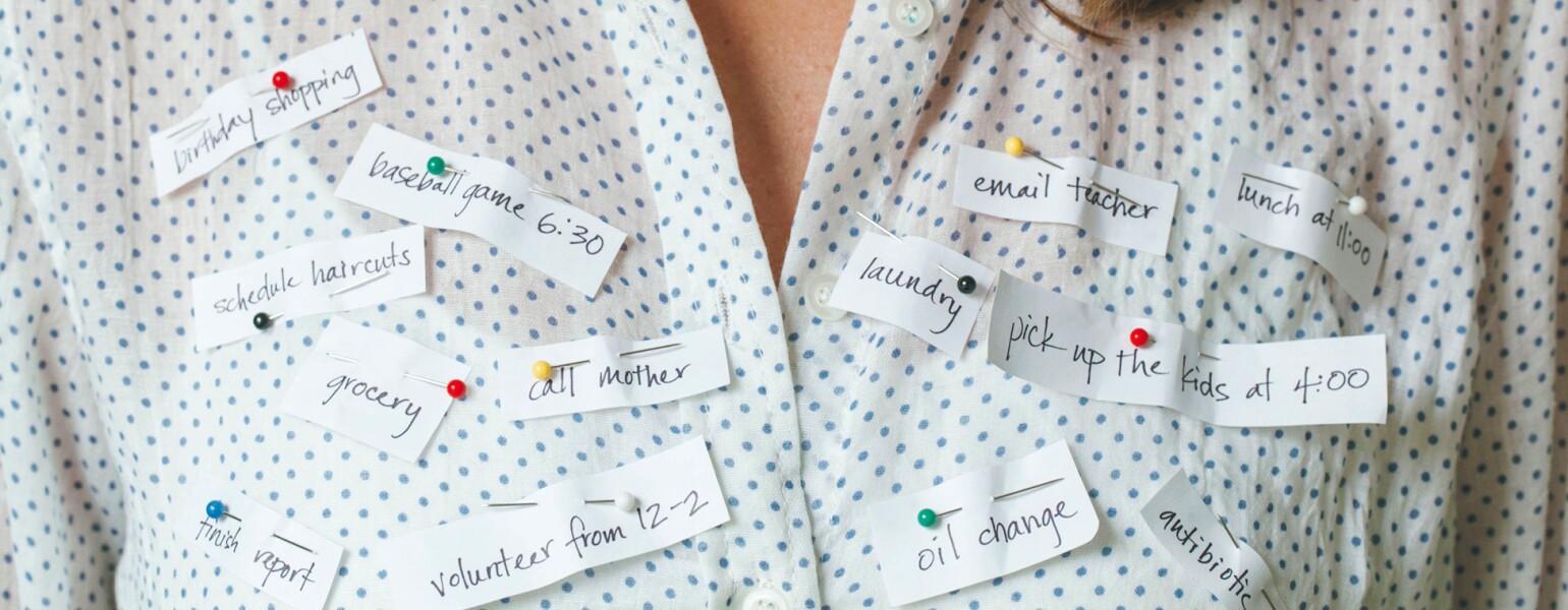 Busy Woman With Reminders Pinned To Her Shirt