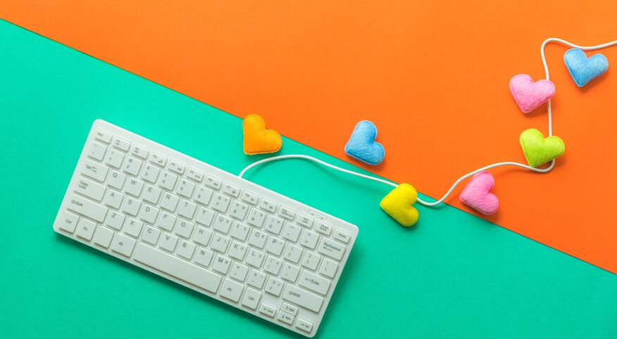 Directly Above Shot Of Computer Keyboard With Colorful Heart Shapes Over Colored Background