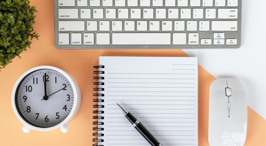 image_of_flat_lay_of_notebook_clock_keyboard_GettyImages-1152254894_1800