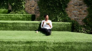 A woman practicing mindful eating sitting in the grass