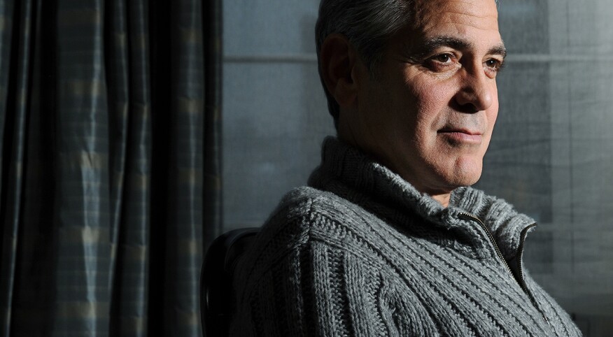 George Clooney poses for a portrait wearing a grey sweater at the Carlyle, a Rosewood Hotel on Wednesday February 05, 2014 in New York, NY