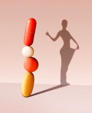 photo illustration of weight loss pills forming a human silhouette shadow on wall