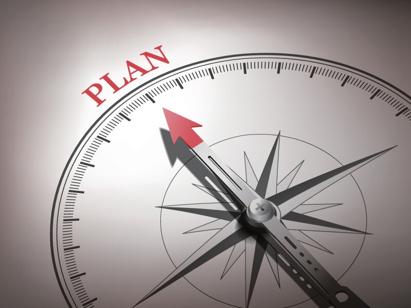 abstract compass needle pointing the word plan
