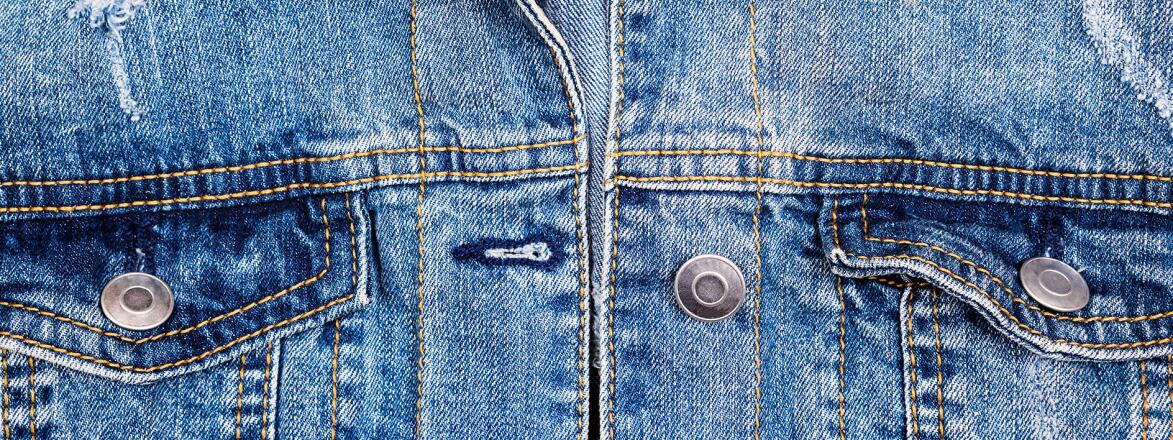 Up close photo of a classic blue denim jean jacket