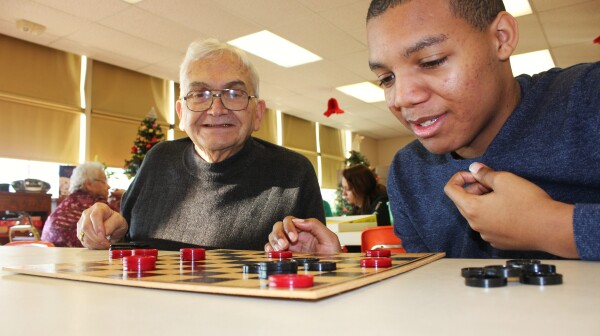 Sage Ted and Seeker Kyree play each other in a game of checkers during the Sages & Seekers program in Spring Grove, PA.