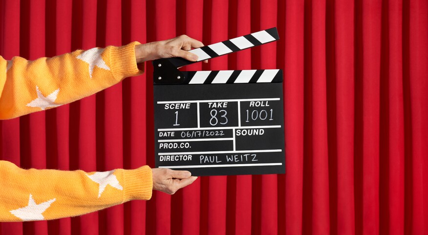 Hands holding film clapperboard