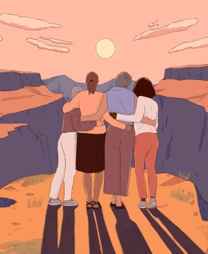 Grouping of 4 women hugging and looking at a sunset together