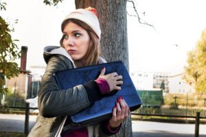 Student gripping her laptop cautiously