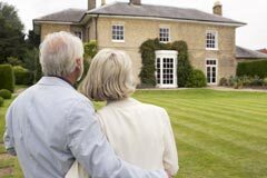 Senior couple admiring house.
