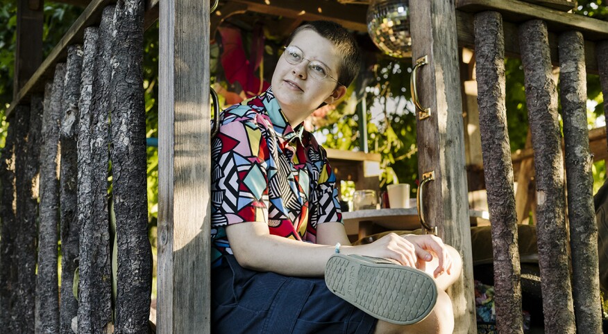 portrait of boy in backyard treehouse