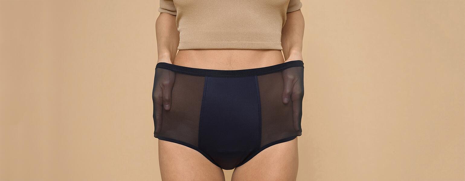 A woman stretches out the sides of her Thinx hi-waist panties, which can double for bladder leakage.