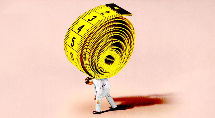 A man hunched over with a extremely large tape measure on his back