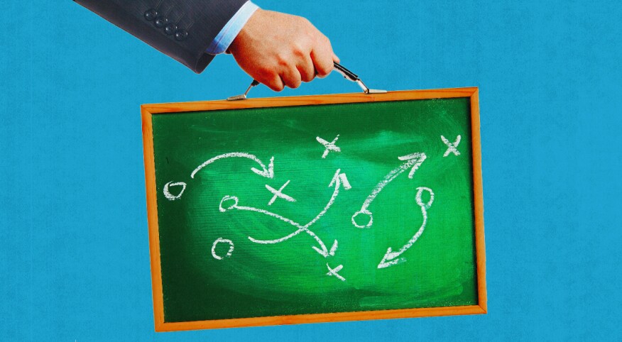 Illustration if hand carrying chalkboard in place of briefcase with sports plays written on them