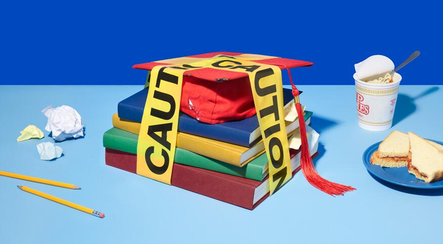 Stack of college textbooks and mortarboard wrapped in caution tape