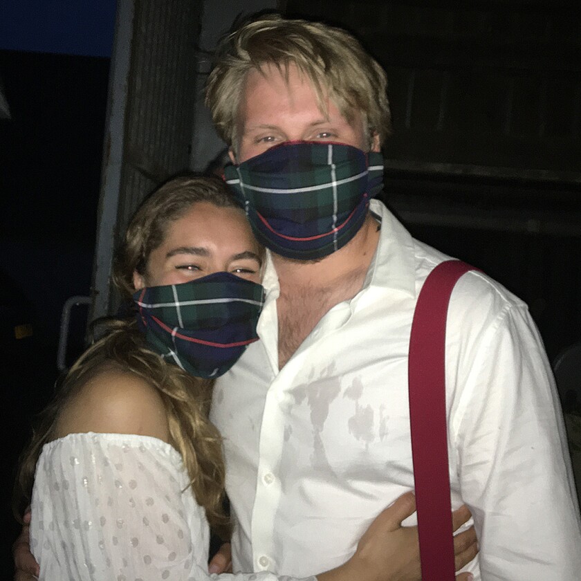 bride and groom in matching tartan masks