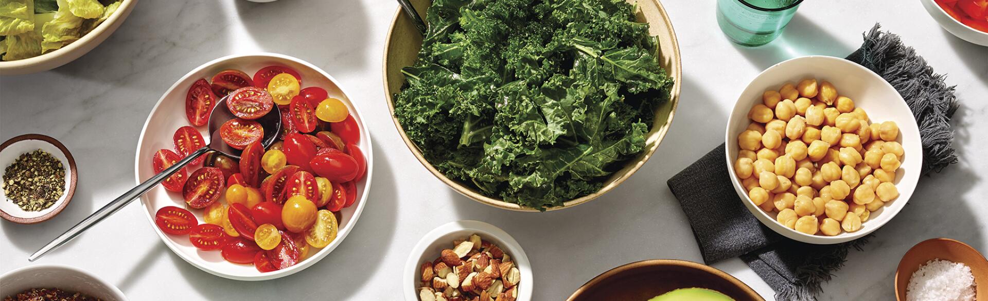 table top with vegetables and quinoa to make a vegan meal
