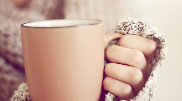 close-up of woman's hands holding a mug