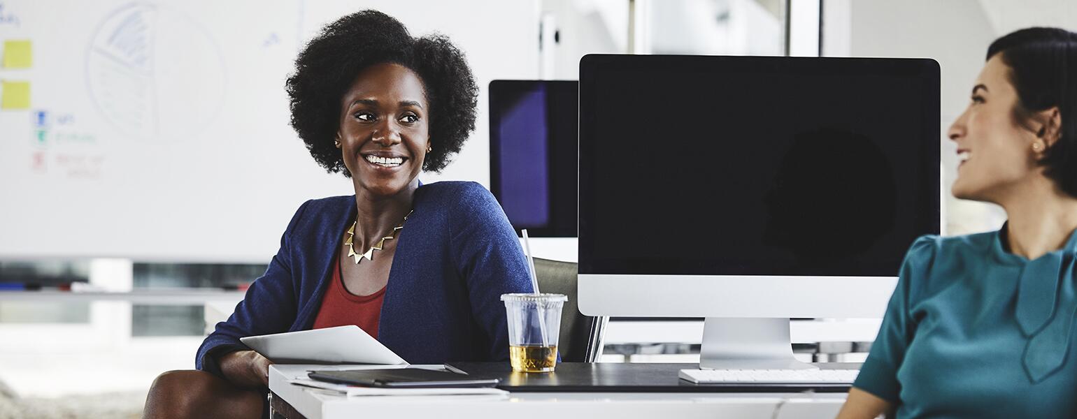 Two women at their job working happily together.