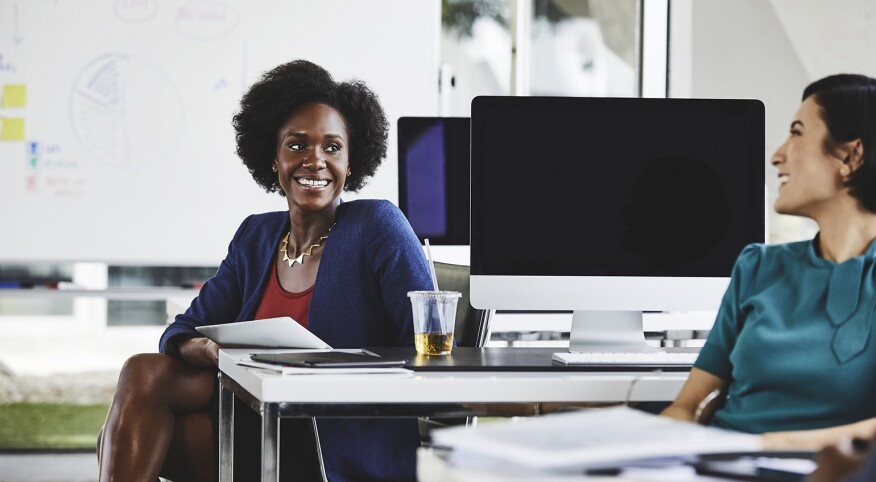 Two women at their job working happily together.