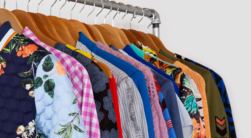 image of clothes on rack by armoire